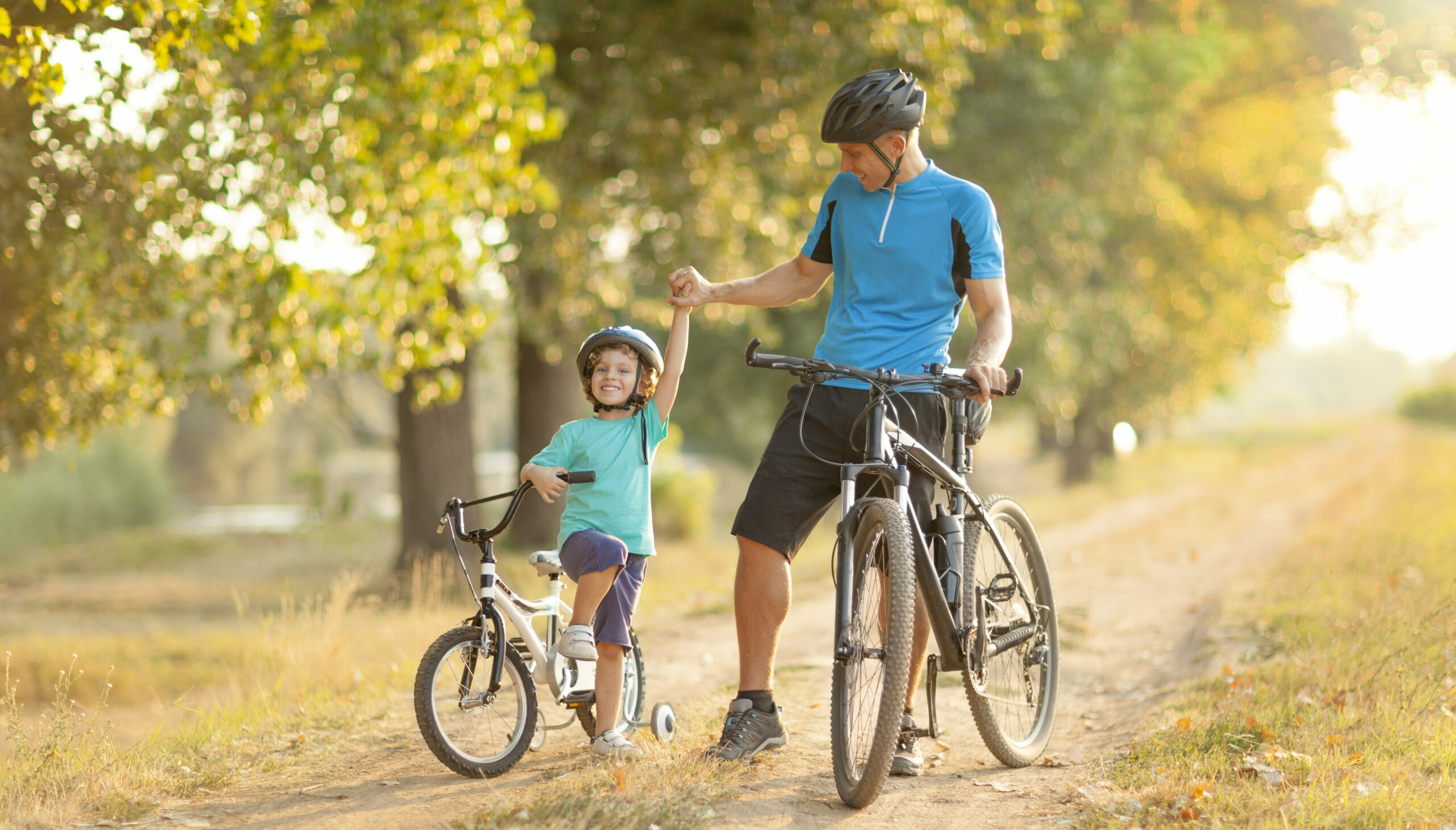 Father and son riding their bikes on a sunny day highlighting things to do near Wimauma and family-friendly outdoor activities.